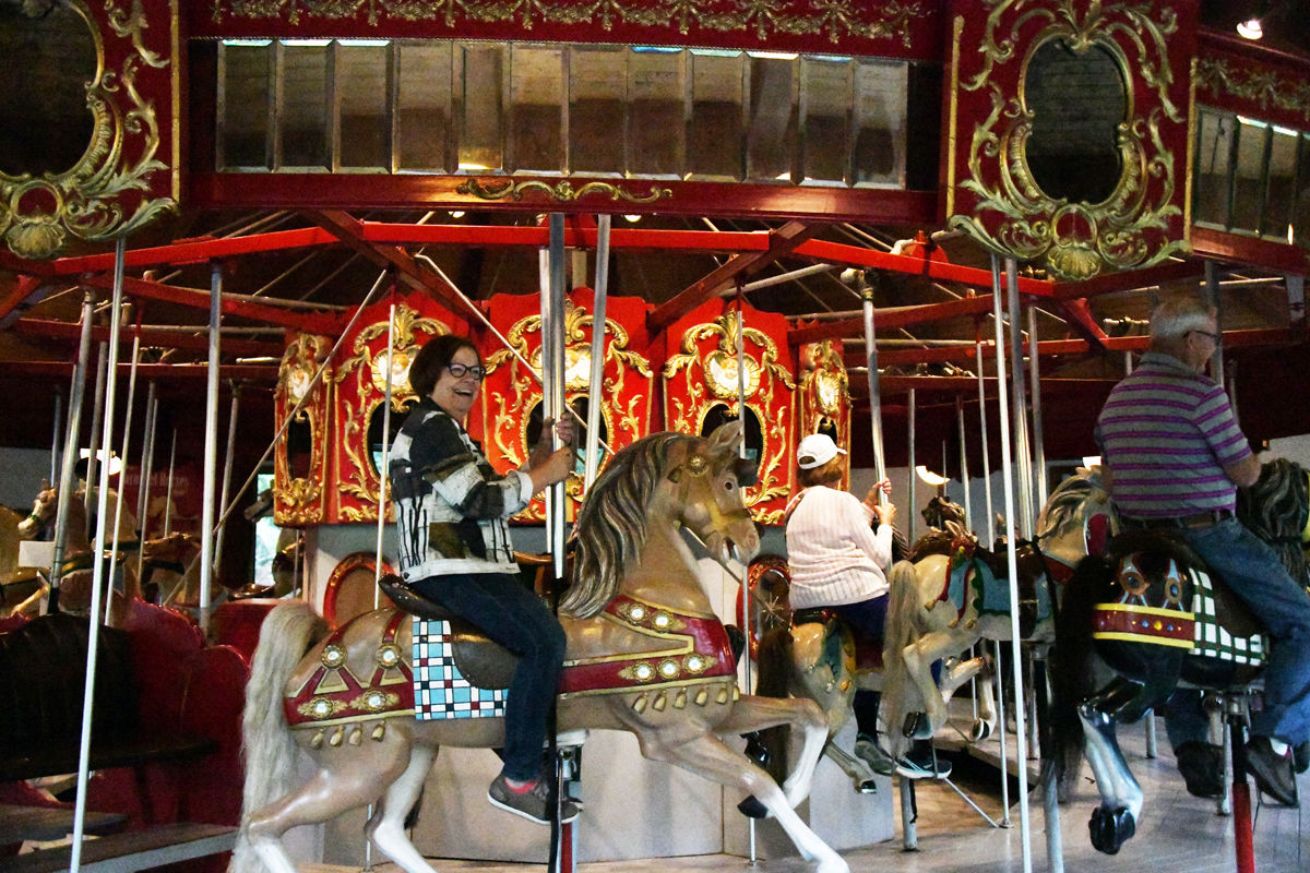 091 Marie Brown enjoys a ride on the handcarved horse on the vintage carousel at Heritage Gardens..jpg
